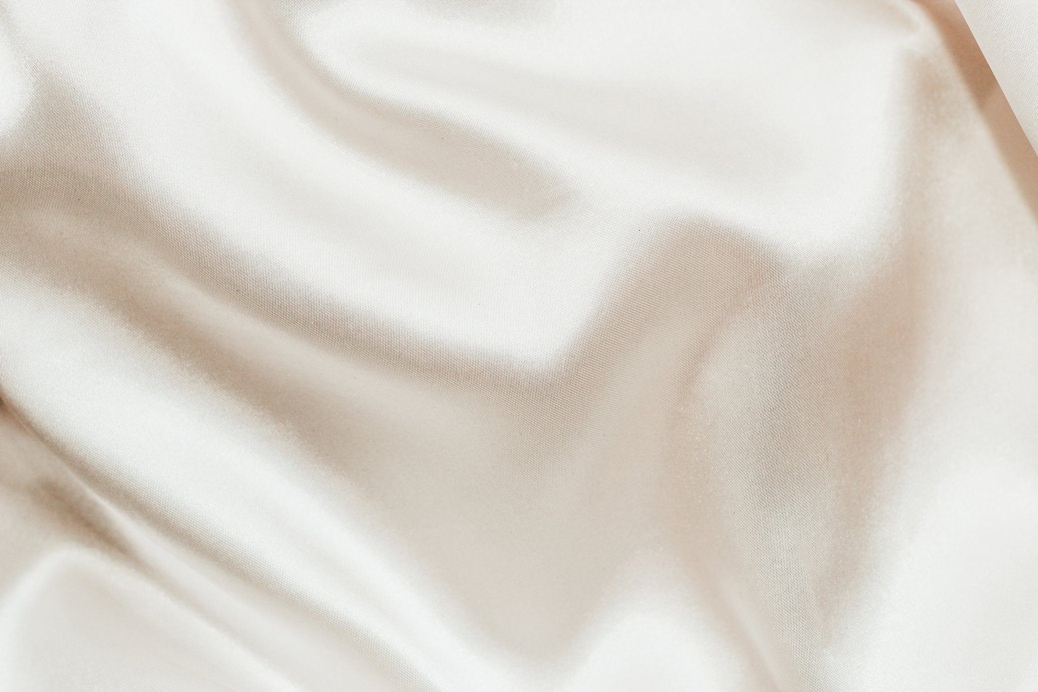 Nude shiny silk satin background with waves